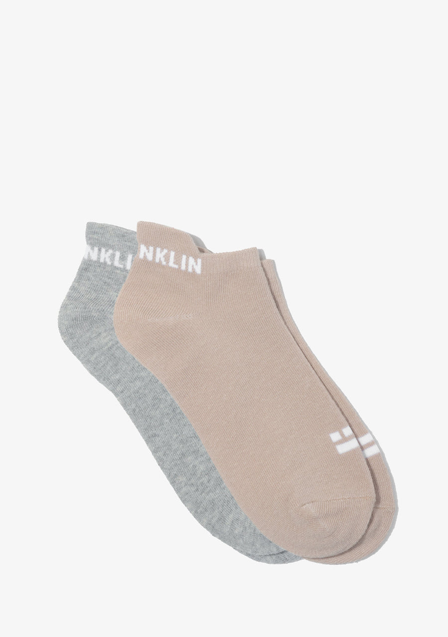 Two pairs of socks, one gray and one beige.